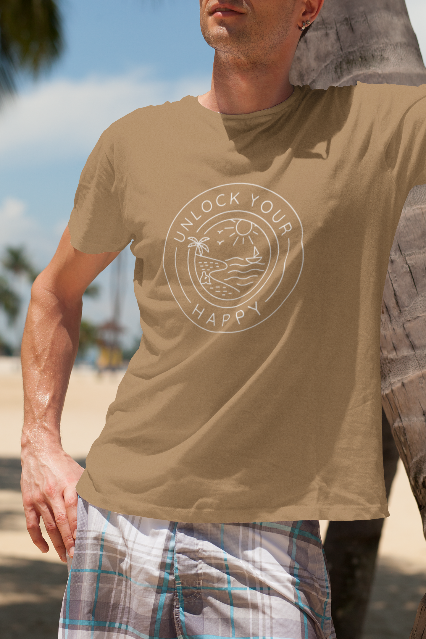 Image of a beach scene with a person sitting on sand under a palm tree, accompanied by text 'Unlock Your Happy' on a T-shirt.